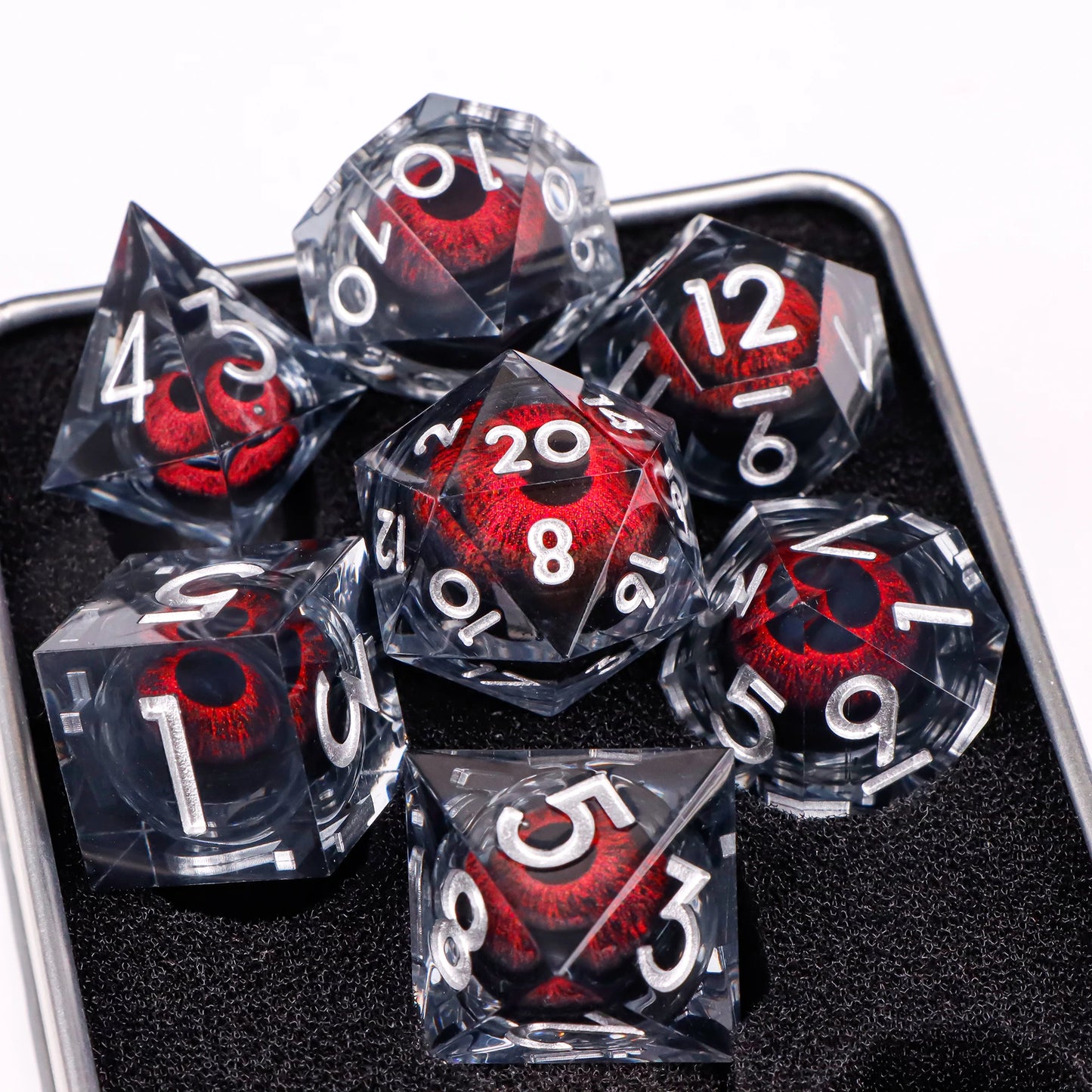 A set of translucent ttrpg dice with white numbering. Inside each die there is a liquid core, containing a red fantasy eye staring upwards.