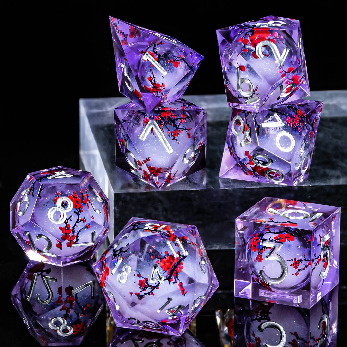 A set of translucent purple acryilic dice with a white glitter and cherry blossom liquid core, with silver numbering.