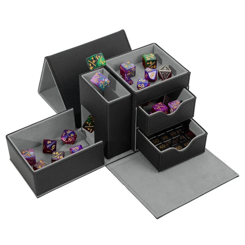 A black faux-leather polyhedral dice storage box shown open, with multiple compartments and two pull-out drawers containing colorful polyhedral gaming dice.