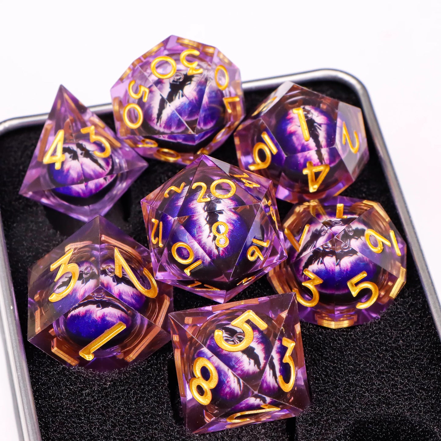 A set of purple translucent ttrpg dice with gold numbering. Inside each die there is a liquid core, containing a fantasy eye staring upwards.