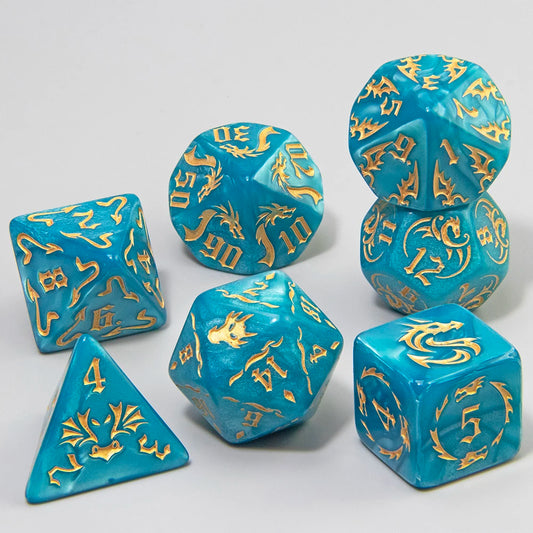 A set of turquoise blue polyhedral dice with gold-colored engraved symbols, arranged on a light gray background.