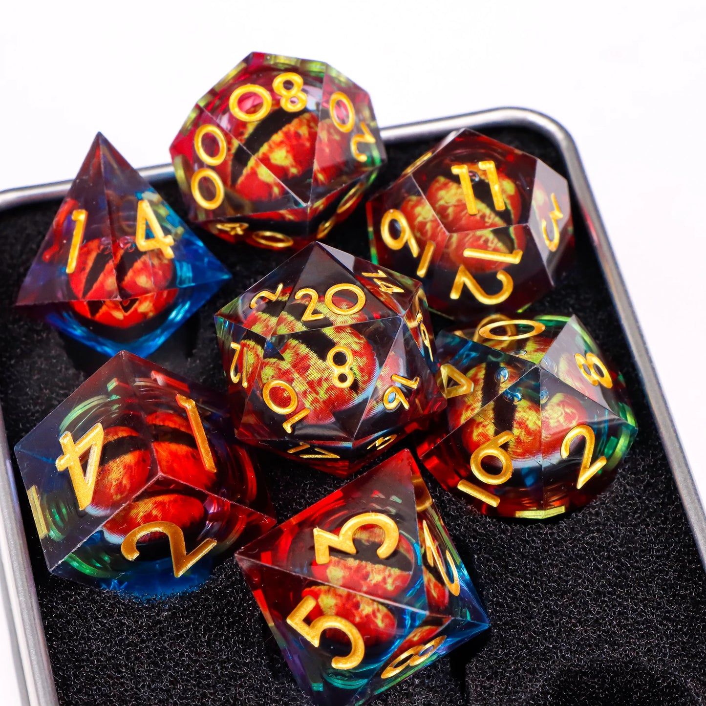 A set of multicolored translucent ttrpg dice with gold numbering. Inside each die there is a liquid core, containing a fantasy eye staring upwards.