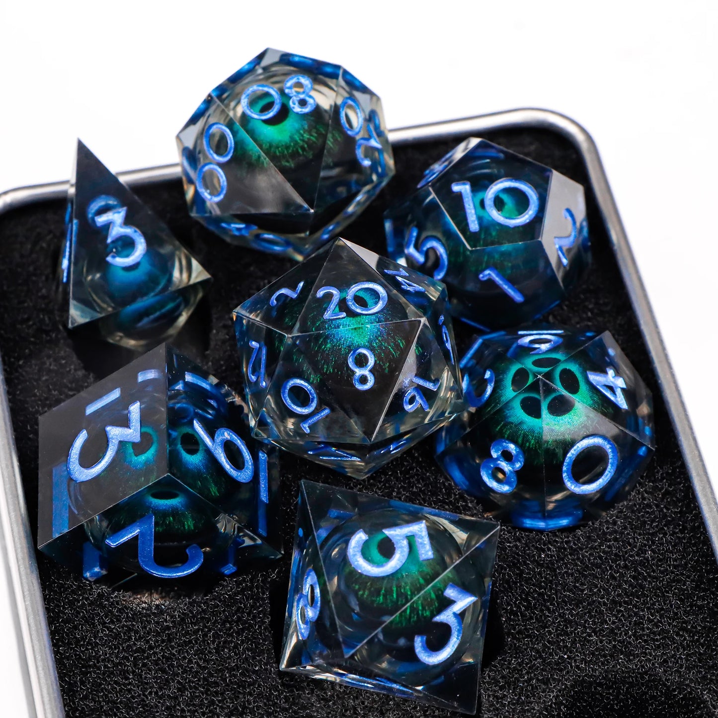 A set of blue translucent ttrpg dice with blue numbering. Inside each die there is a liquid core, containing a fantasy eye staring upwards.