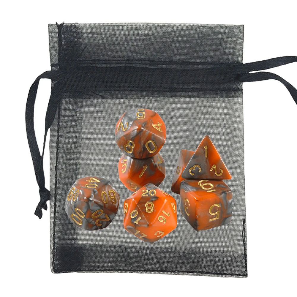 A set of orange and dark gray marbled polyhedral gaming dice displayed in front of a black sheer drawstring pouch on a white background.