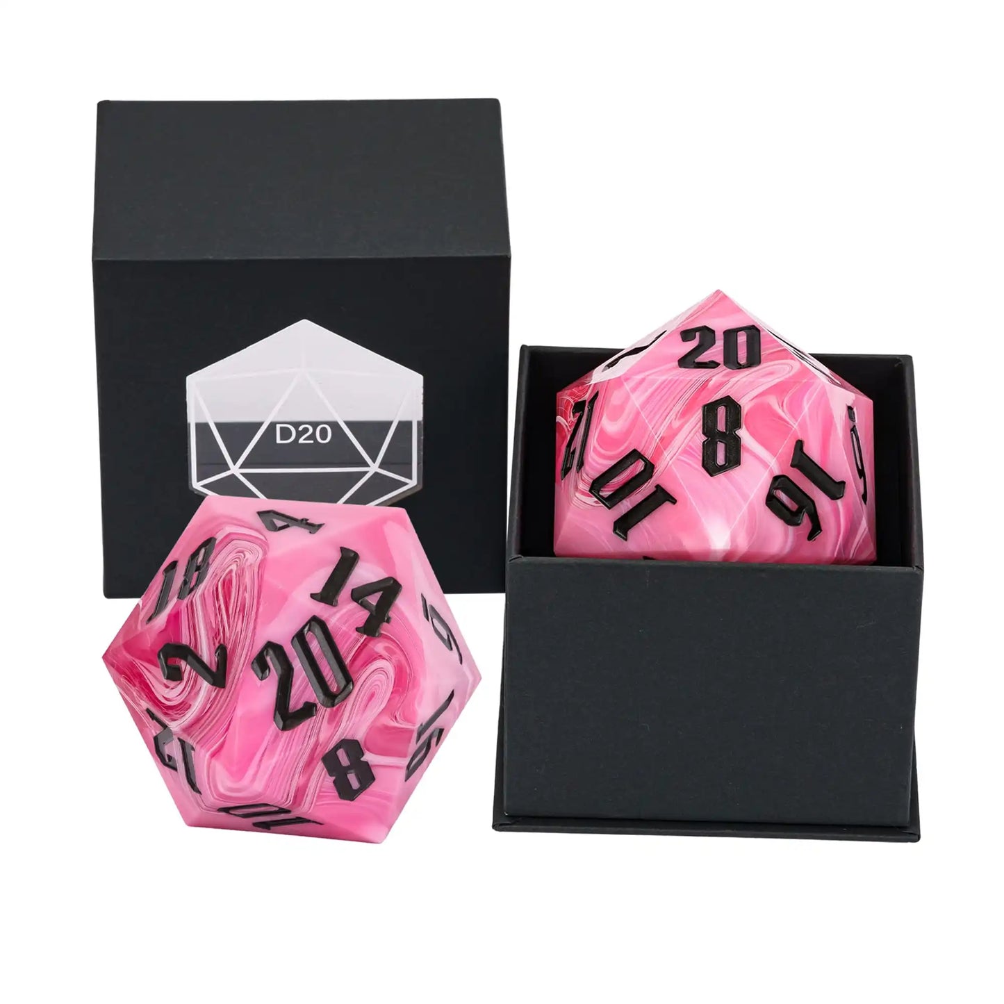 A pink marbled D20 polyhedral gaming die with black numbering, shown alongside a matching black gift box with a white D20 icon and another open box containing a matching die.