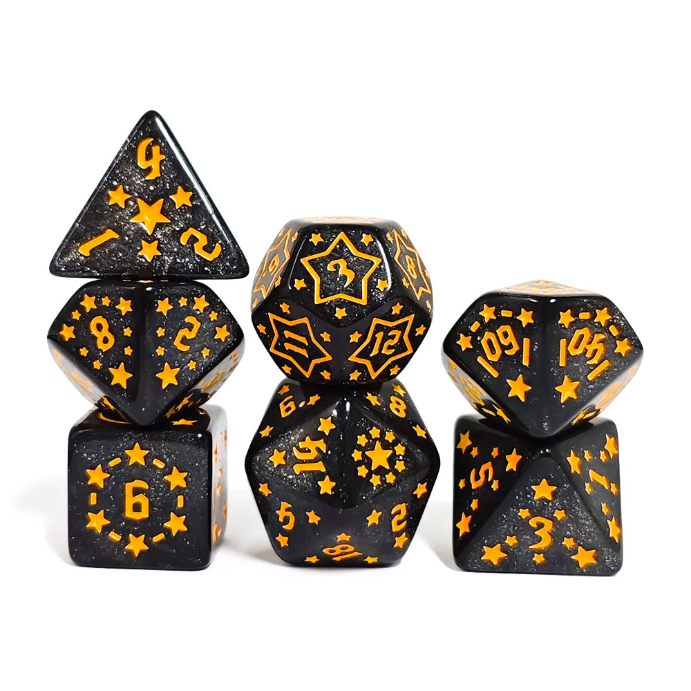 Set of black dice with gold numbers and star patterns on a white background