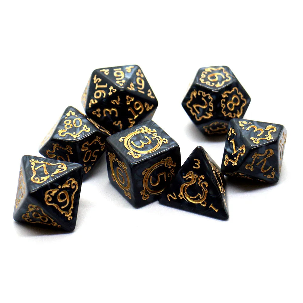 Black dice with gold numbering and symbols on a white background