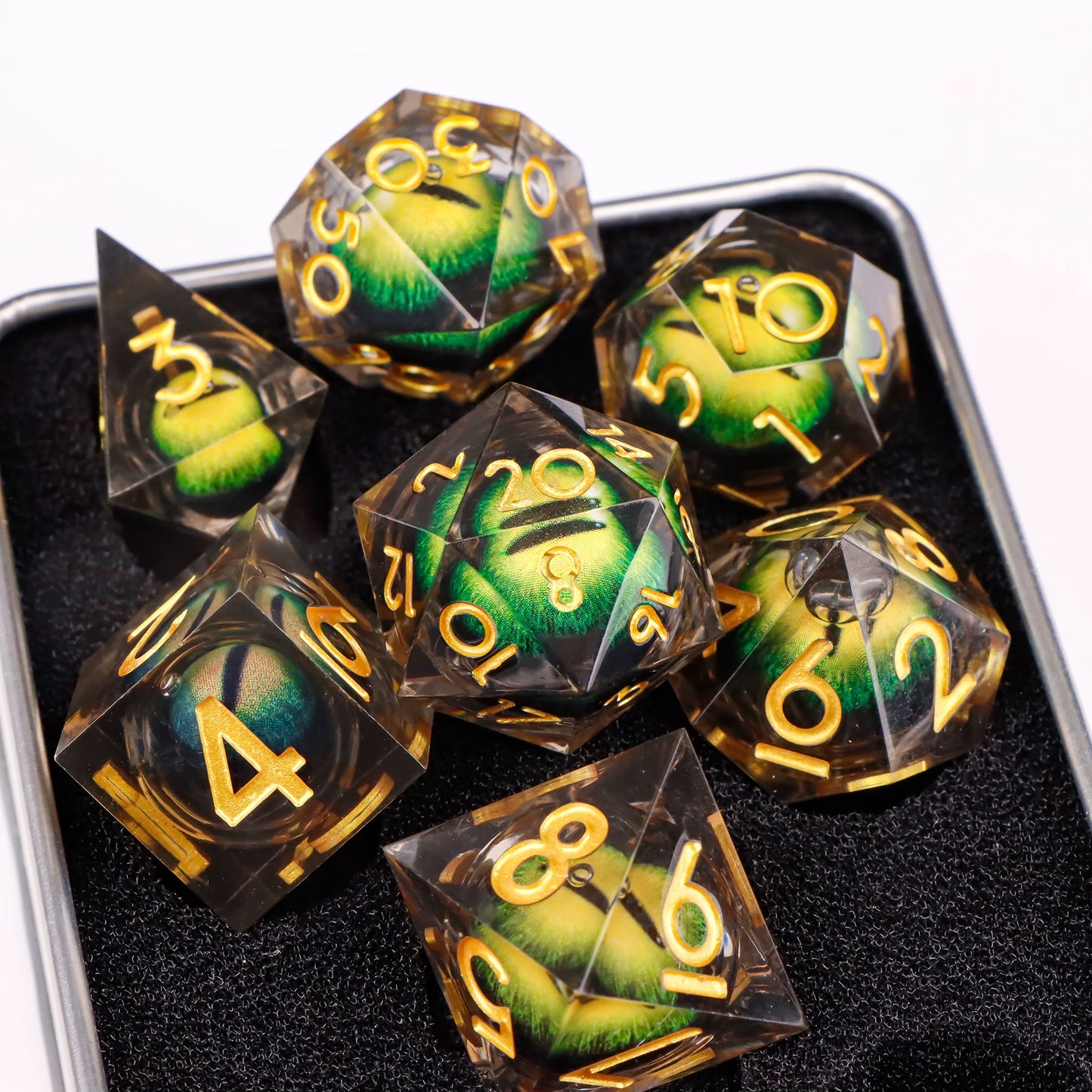 A set of translucent ttrpg dice with yellow numbering. Inside each die there is a liquid core, containing a fantasy eye staring upwards.
