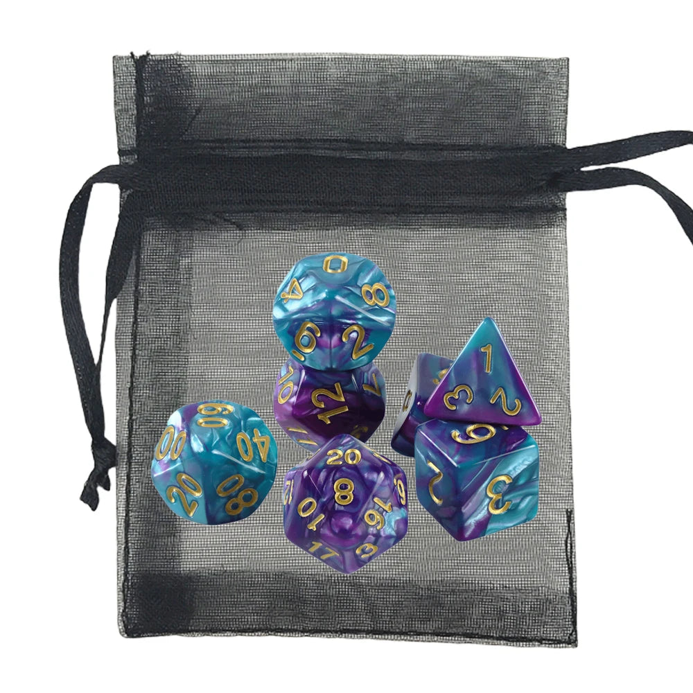 A set of polyhedral gaming dice in marbled blue and purple with gold numbers, displayed next to a black sheer mesh drawstring bag on a white background.
