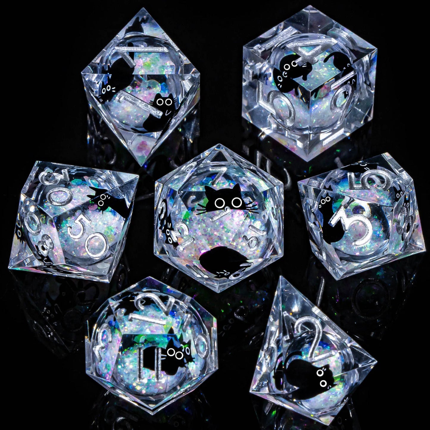 A set of transparent acryilic dice with a clear / iridecent glitter and cartoon cat liquid core, with silver numbering. 