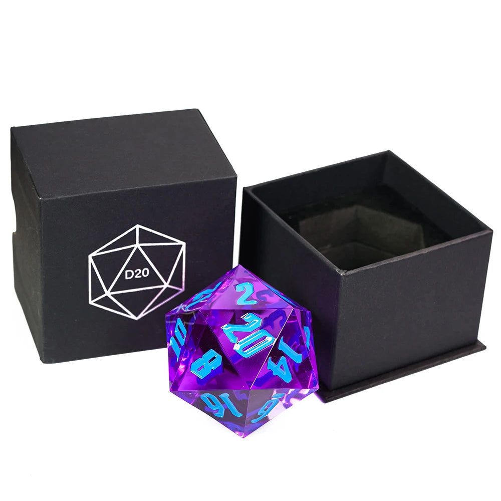 A translucent purple 20-sided die with bright blue numbering, shown next to its open black presentation box and a closed black box with a white D20 symbol.