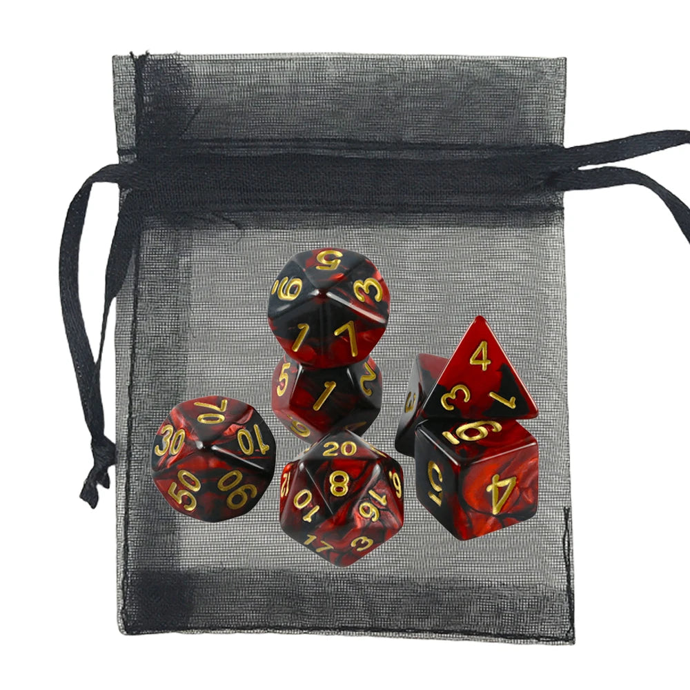 A set of red and black marbled polyhedral dice with gold numbers, displayed alongside a black sheer mesh drawstring bag on a white background.
