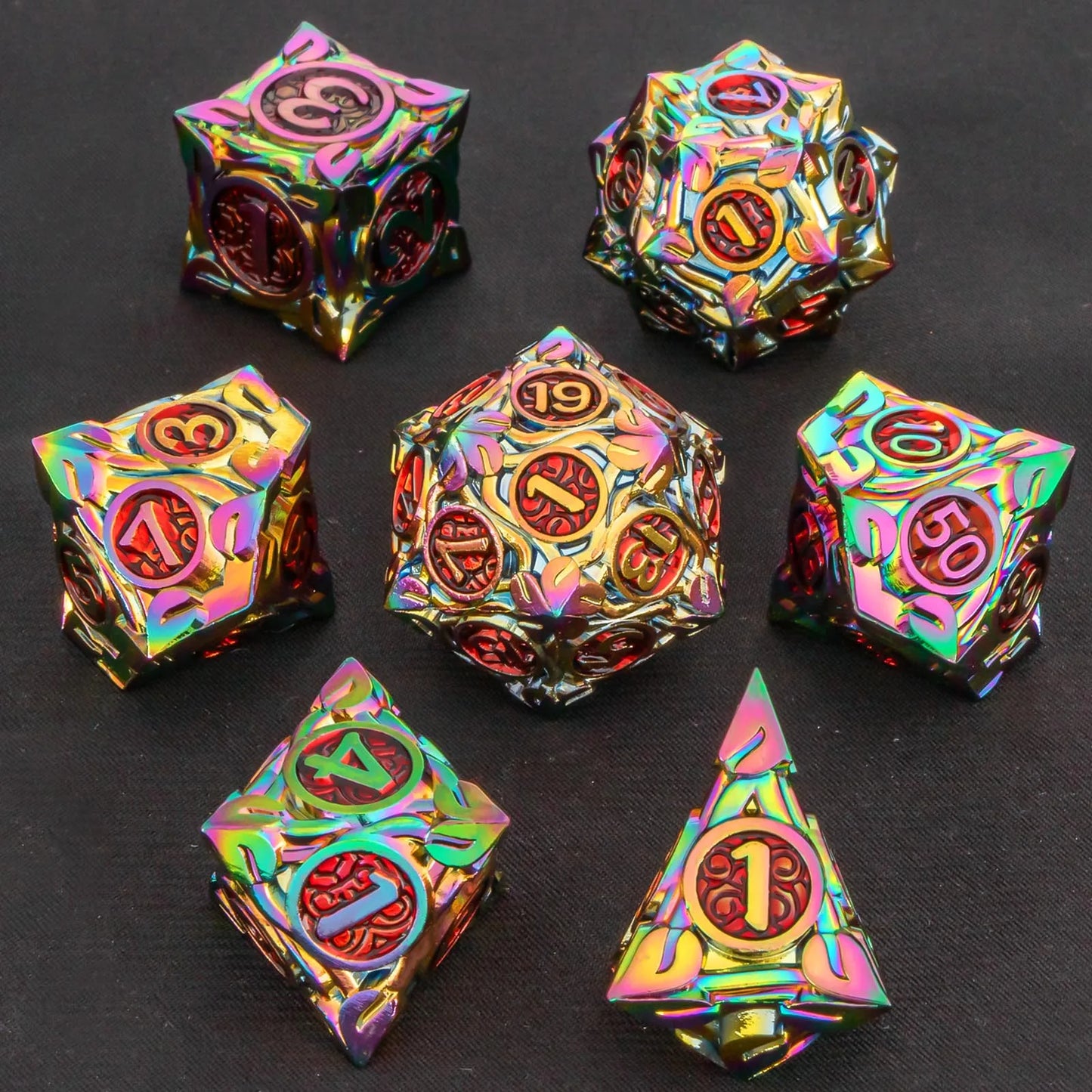 A 7-piece metal polyhedral gaming dice set with an iridescent rainbow finish, displayed on a dark textured background.