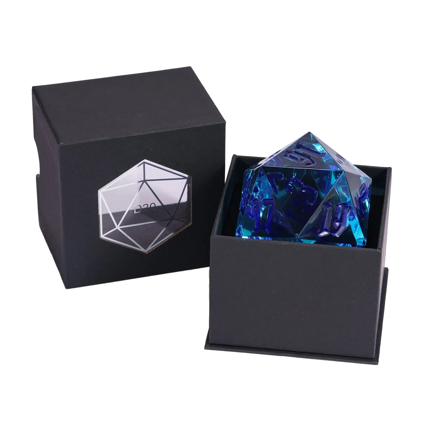 A translucent blue 20-sided die with fark blue numbering, displayed inside an open black presentation box, with the matching closed box shown beside it on a white background.