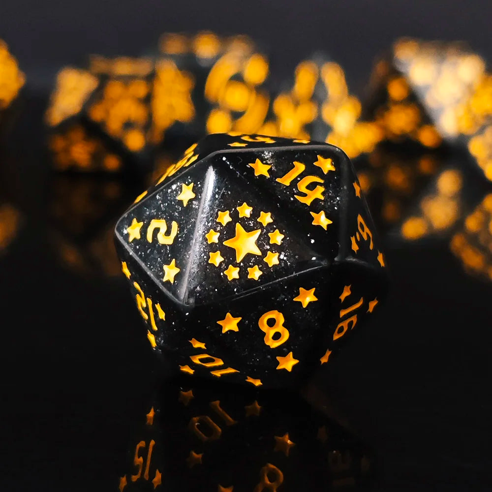 Black polyhedral dice with gold numbers and star patterns on a dark background