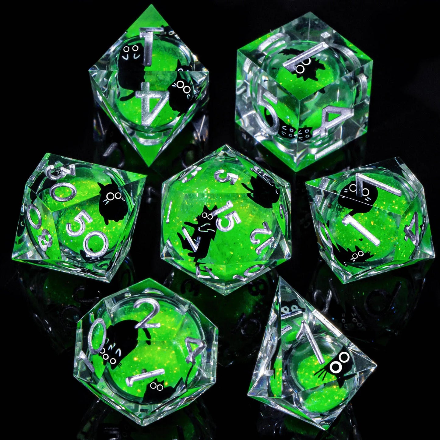 A set of clear acrylic dice with a liquid core, containing bright green glitter and cartoon cats, with silver numbering.