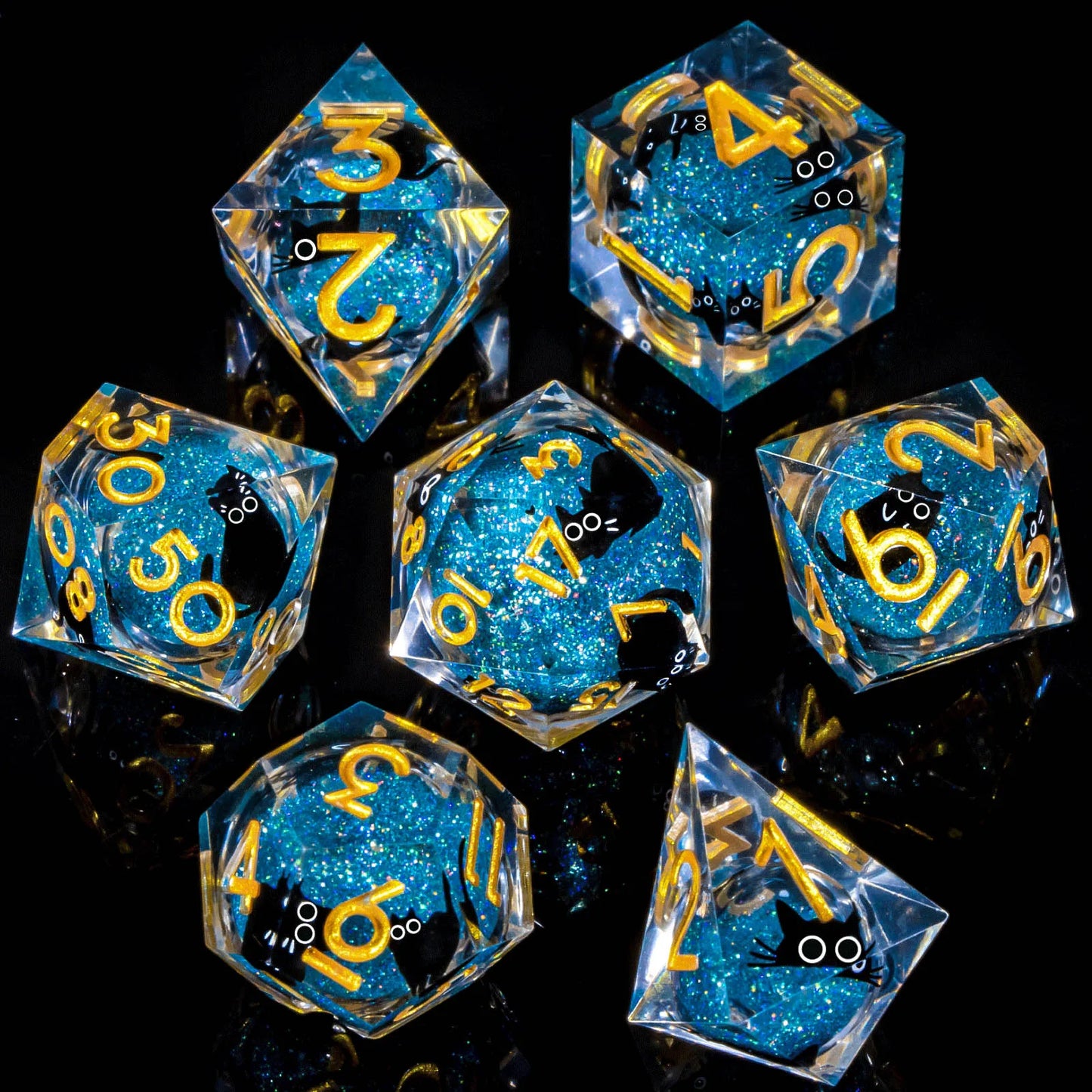A set of transparent acryilic dice with a blue glitter and cartoon cat liquid core, with gold numbering. 
