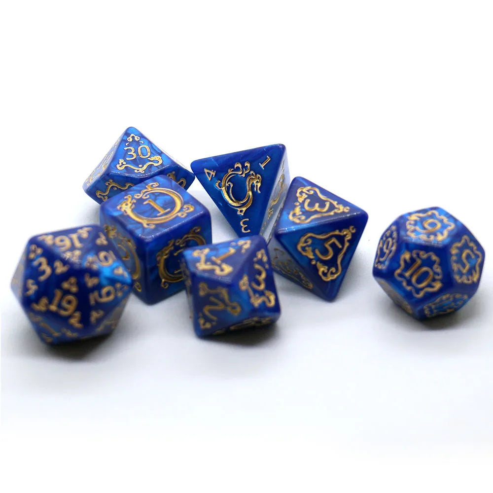 Blue polyhedral dice set with gold numbering on a white background