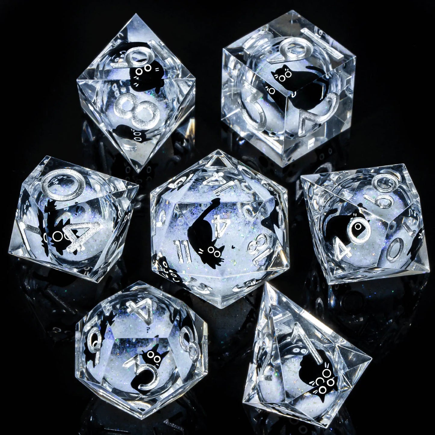 A set of transparent acryilic dice with a white glitter and cartoon cat liquid core, with silver numbering. 