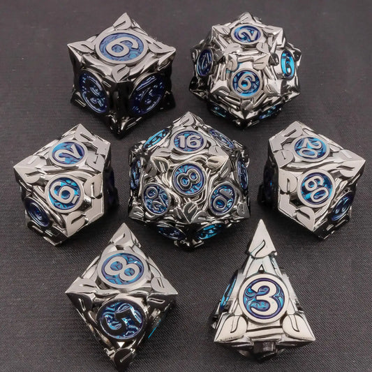 A set of metal fantasy tabletop gaming dice in a dark metallic silver finish with blue and black engraved details, arranged on a dark textured background.
