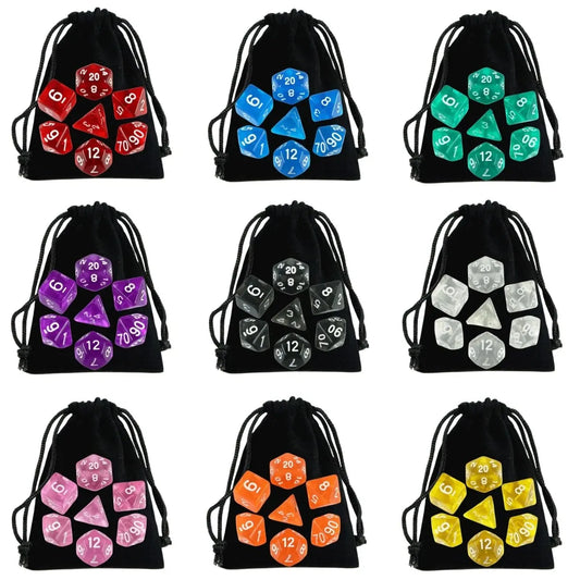 Set of nine black drawstring bags with various colored polyhedral dice sets on a white background