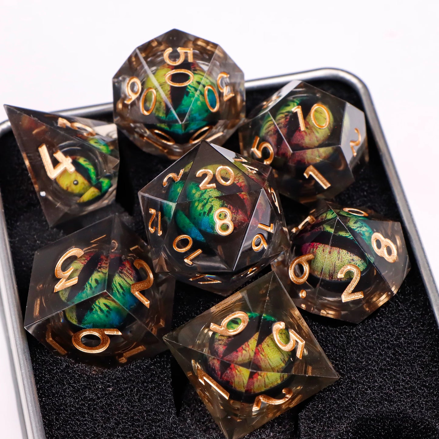 A set of translucent ttrpg dice with broze numbering. Inside each die there is a liquid core, containing a multicolored fantasy eye staring upwards.