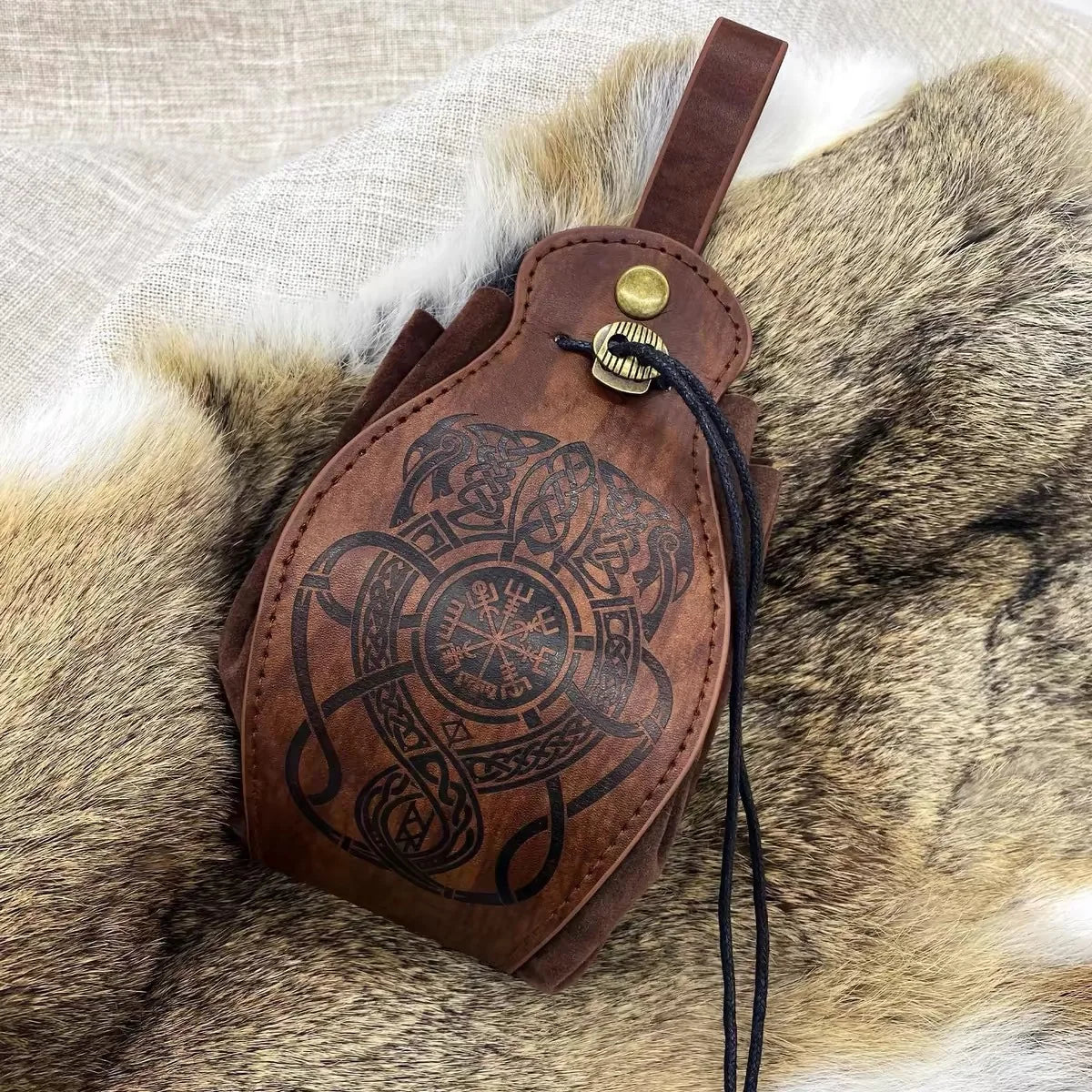 Brown leather pouch with embossed design on fur
