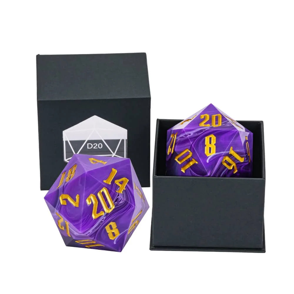 A purple and white marbled 20-sided die set with gold numbers, shown alongside a black presentation box and an open box containing the second die.