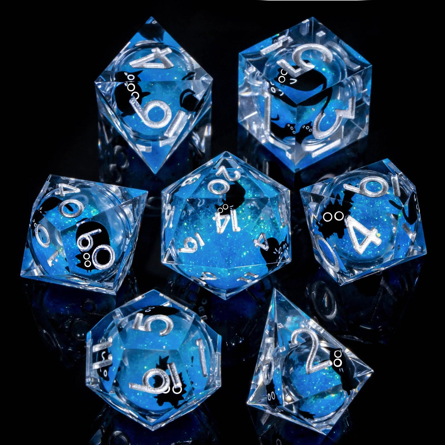 A set of transparent acryilic dice with a blue glitter and cartoon cat liquid core, and silver numbering.