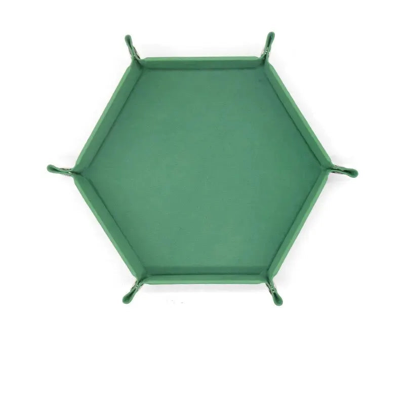 Hexagonal green velvet dice plate on a white background