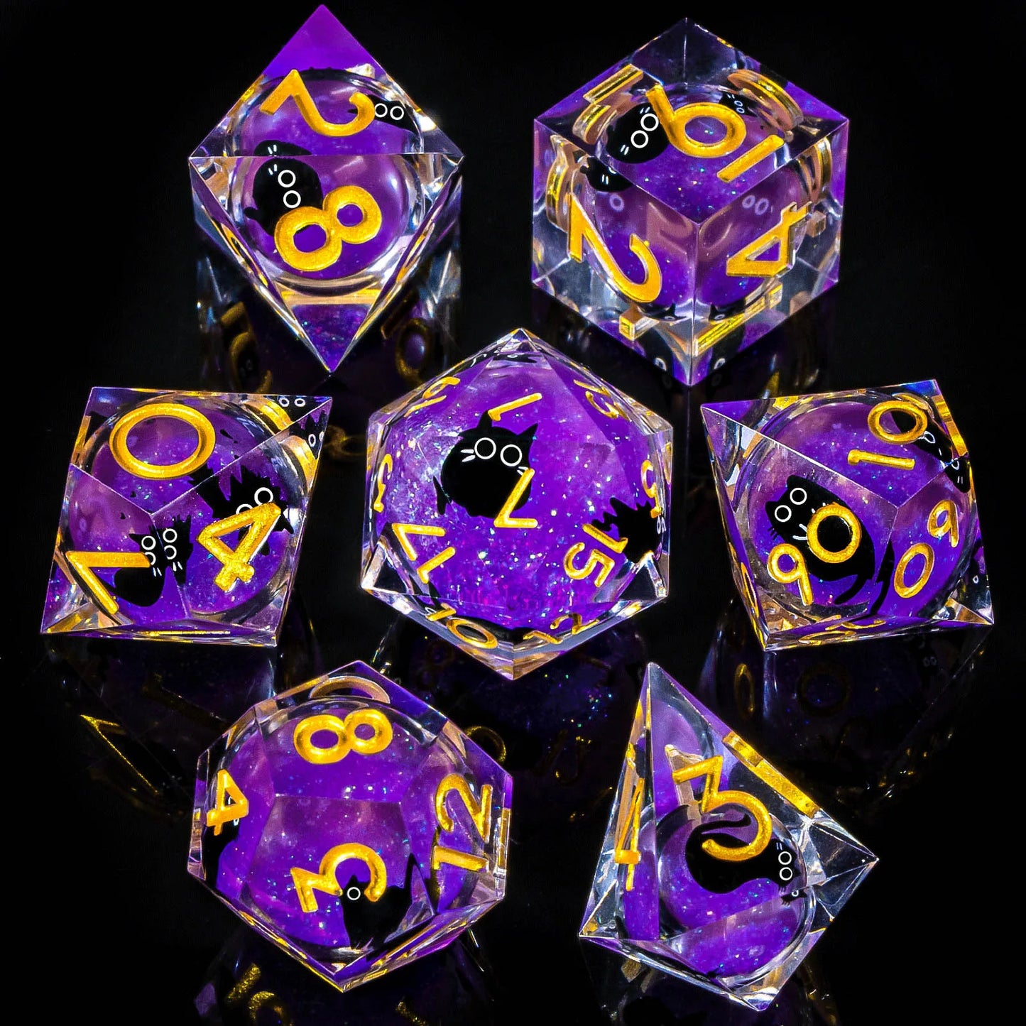 Set of clear polyhedral dice with a liquid core containing purple glitter and and cartoon cats, with yellow numbers on a black background