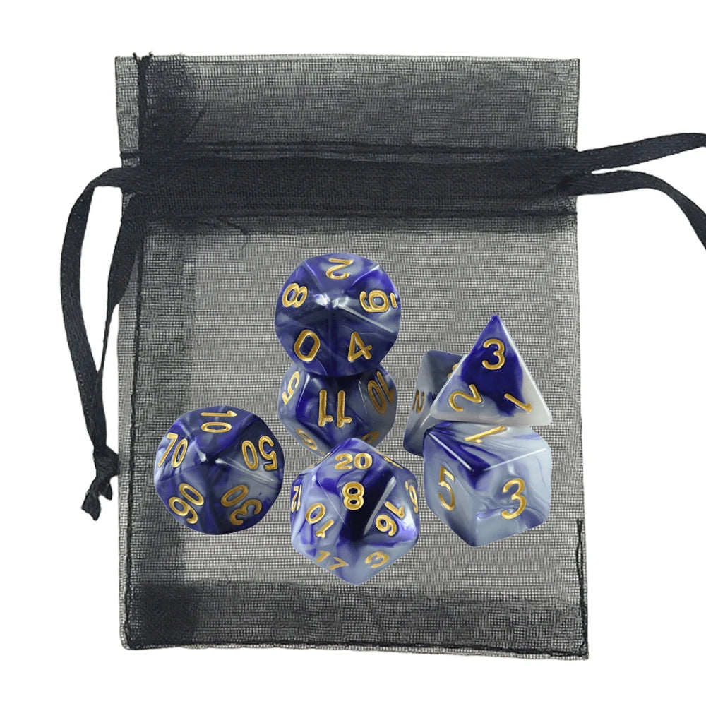 A 7-piece polyhedral dice set with blue and white marbled resin and gold-colored numbers, displayed alongside a black sheer mesh drawstring bag on a white background.