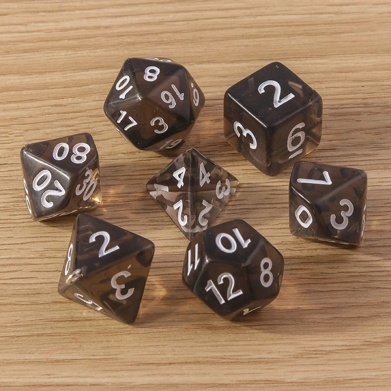 Set of brown polyhedral dice with white numbers on a wooden surface
