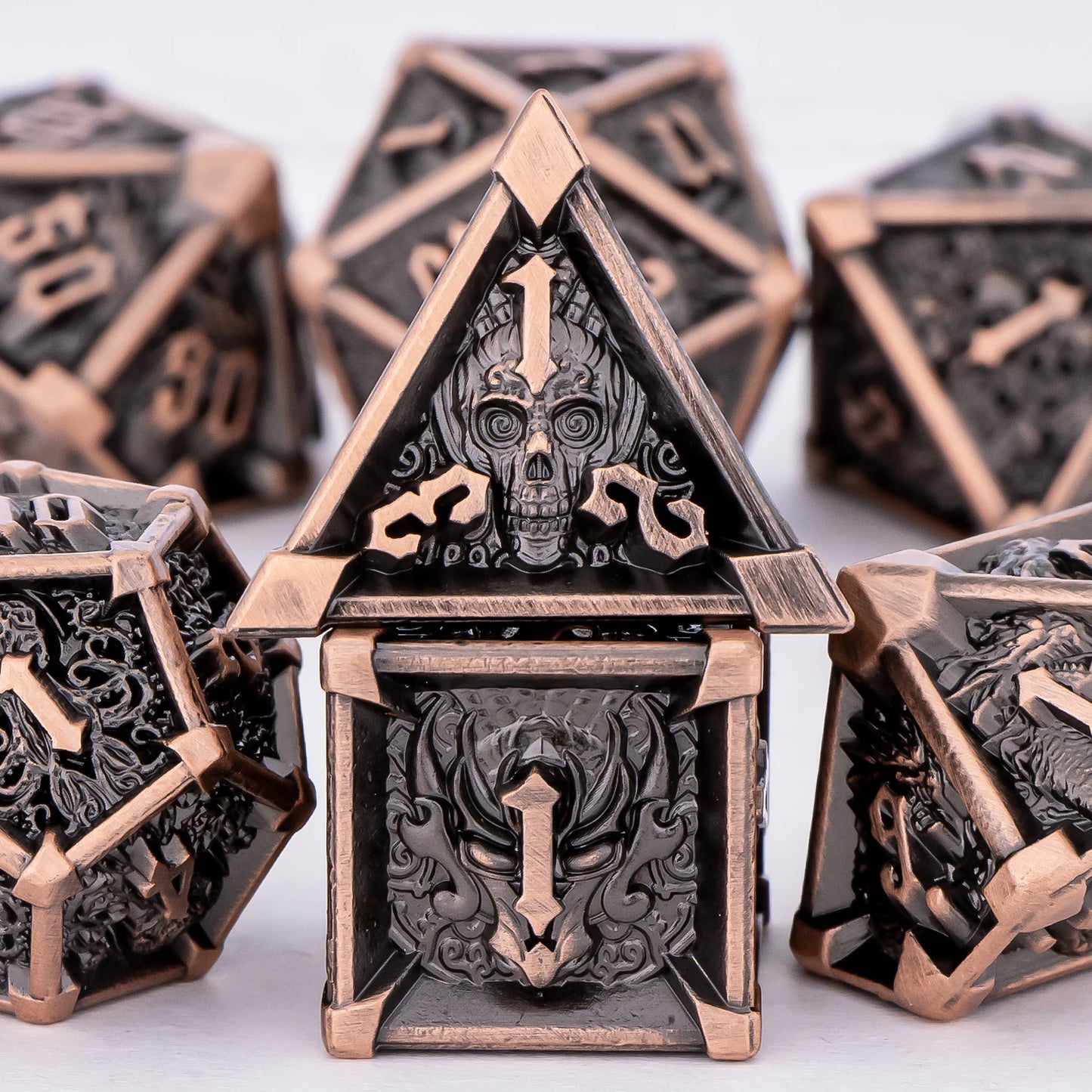 Decorative polyhedral dice with intricate designs on a white background