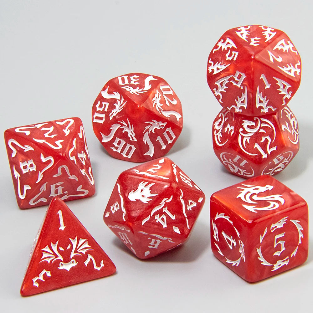 A set of red polyhedral gaming dice with white dragon illustrations, arranged on a light gray background.