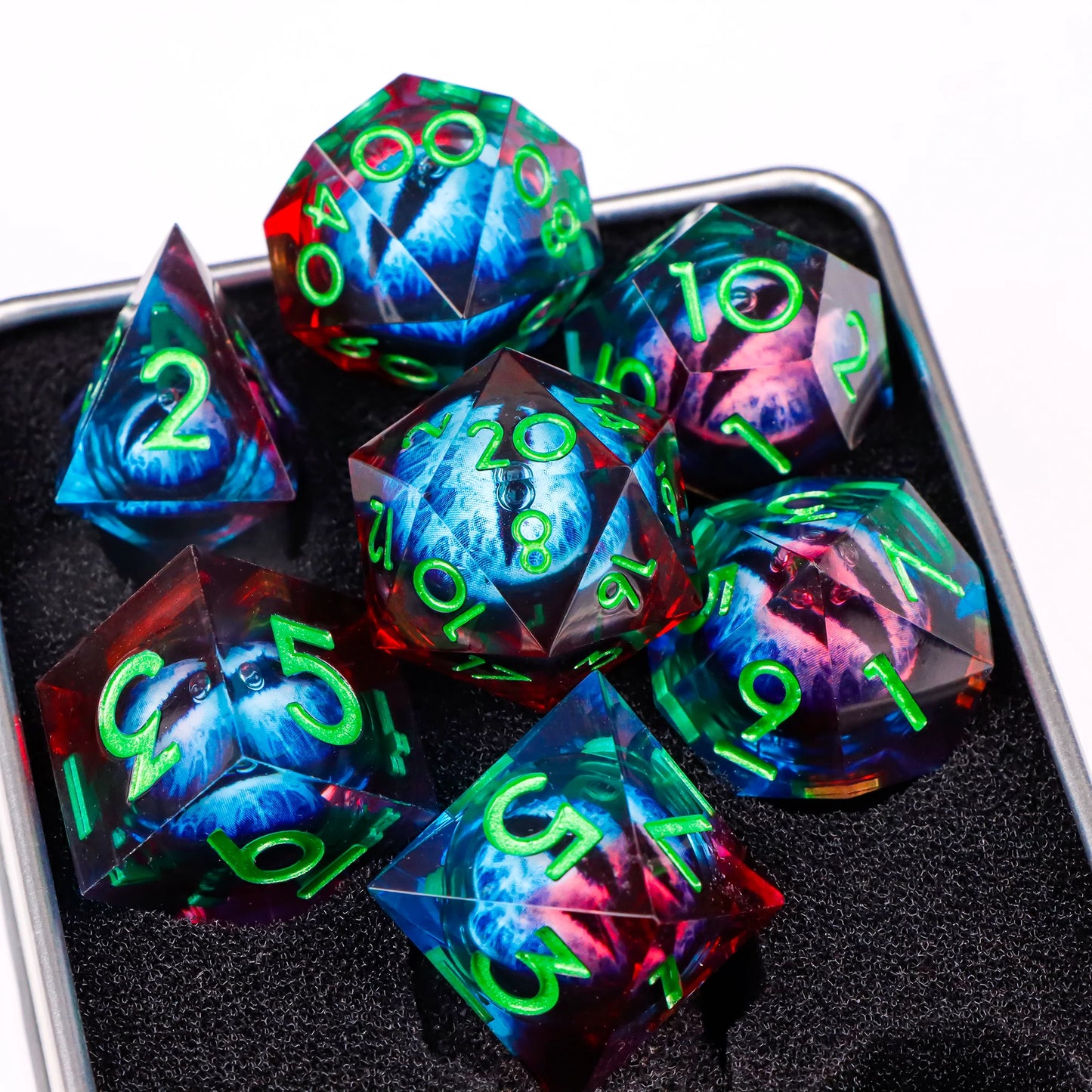 A set of multicolored translucent ttrpg dice with green numbering. Inside each die there is a liquid core, containing a fantasy eye staring upwards.