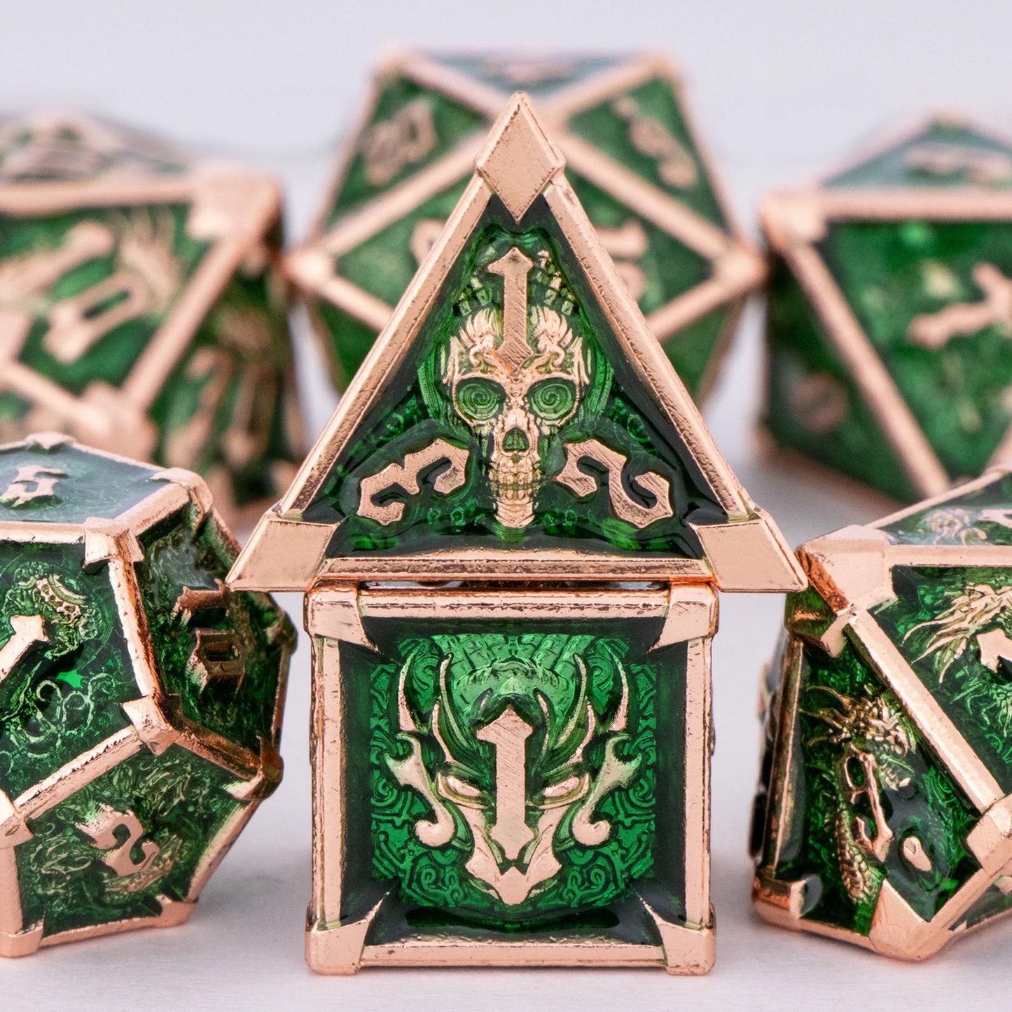 Green and gold polyhedral dice with intricate designs on a white background