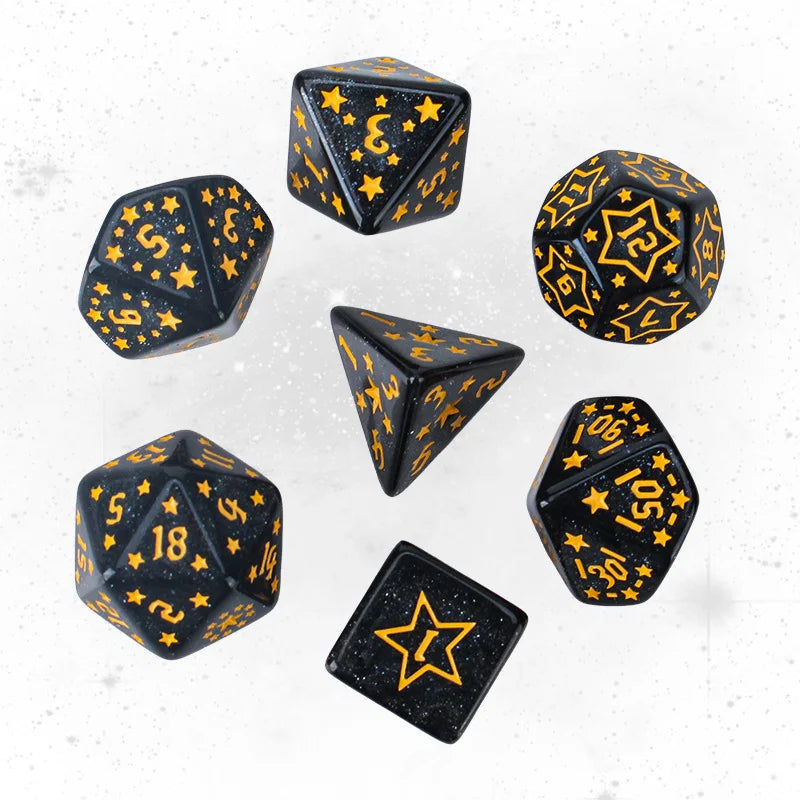Set of black dice with yellow numbering and star patterns on a white background