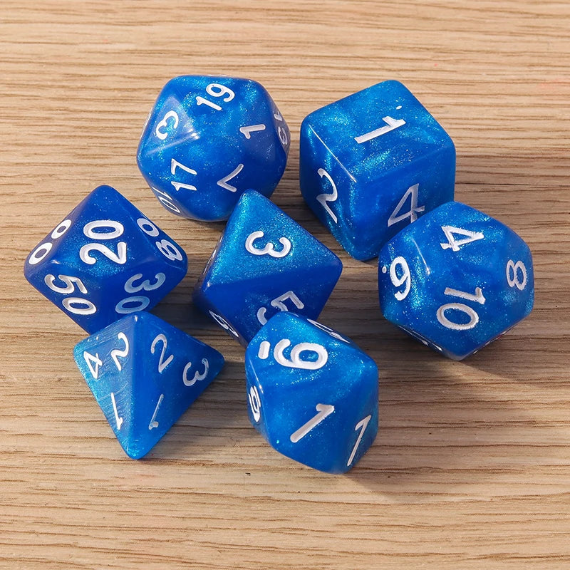 Blue polyhedral dice with white numbers on a wooden surface