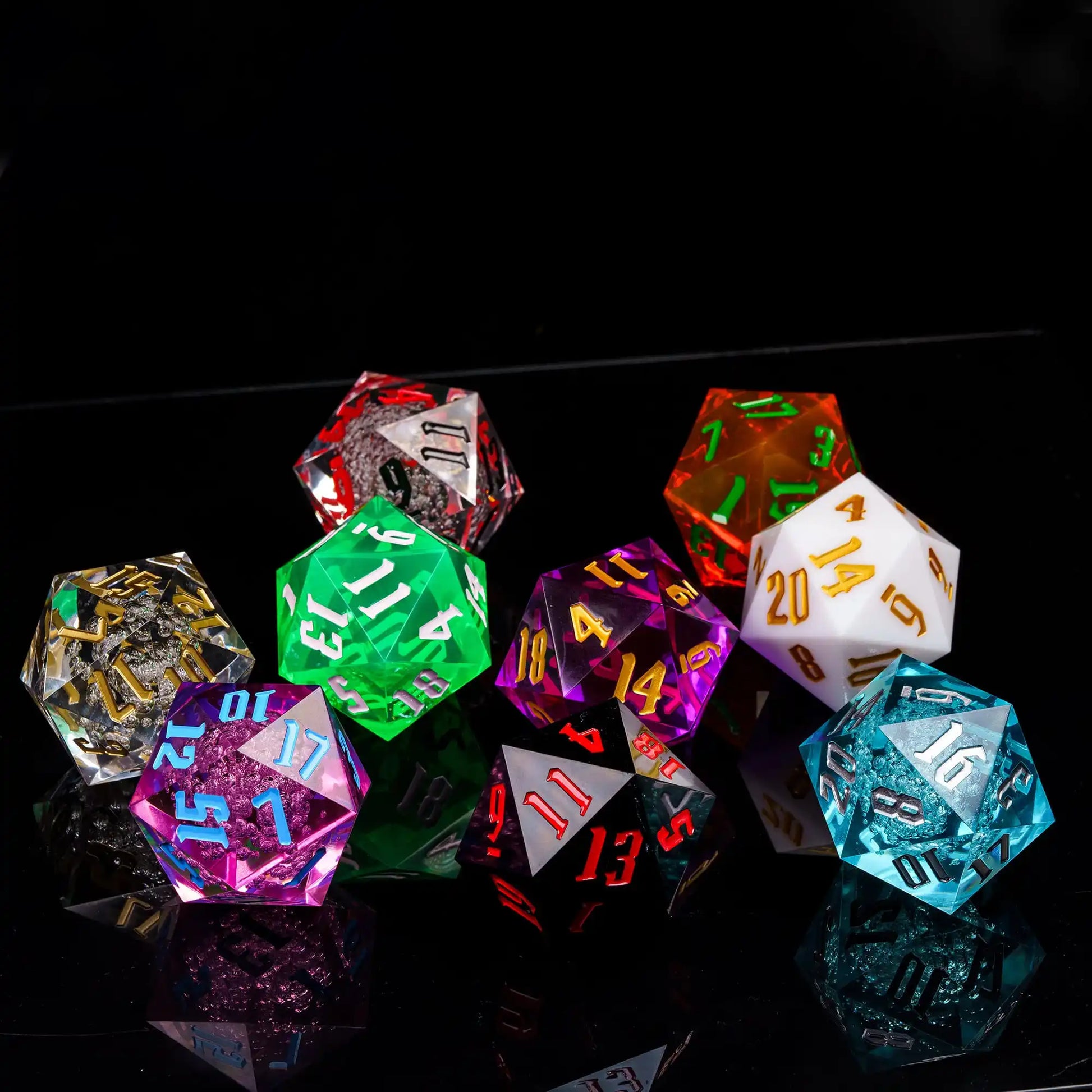 A group of translucent polyhedral dice in multiple colors, including red, green, purple, orange, white, blue, and black, arranged on a glossy black reflective surface against a black background.