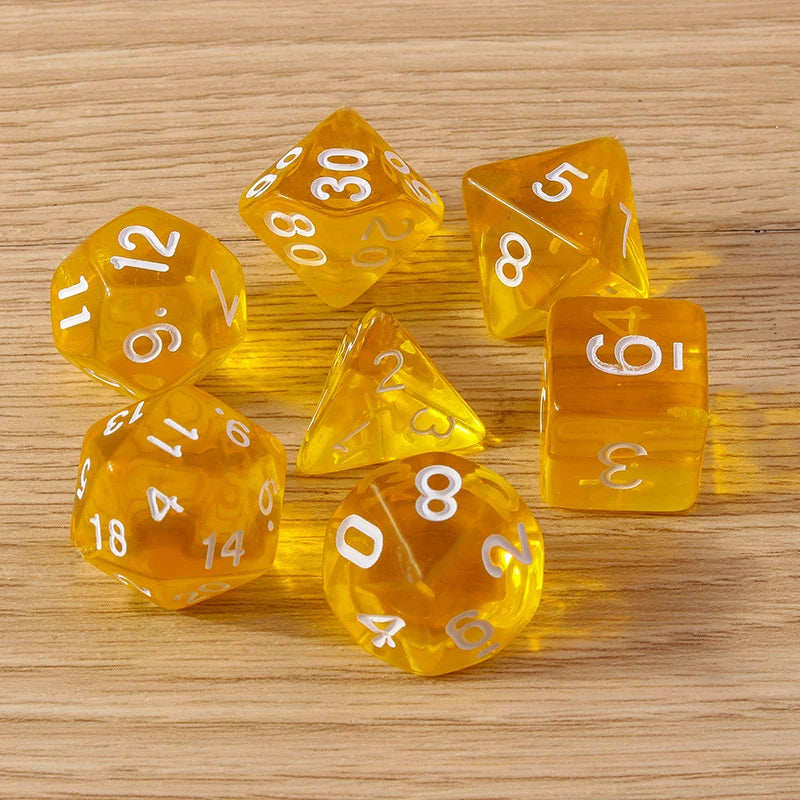 Set of orange polyhedral dice with white numbers on a wooden surface