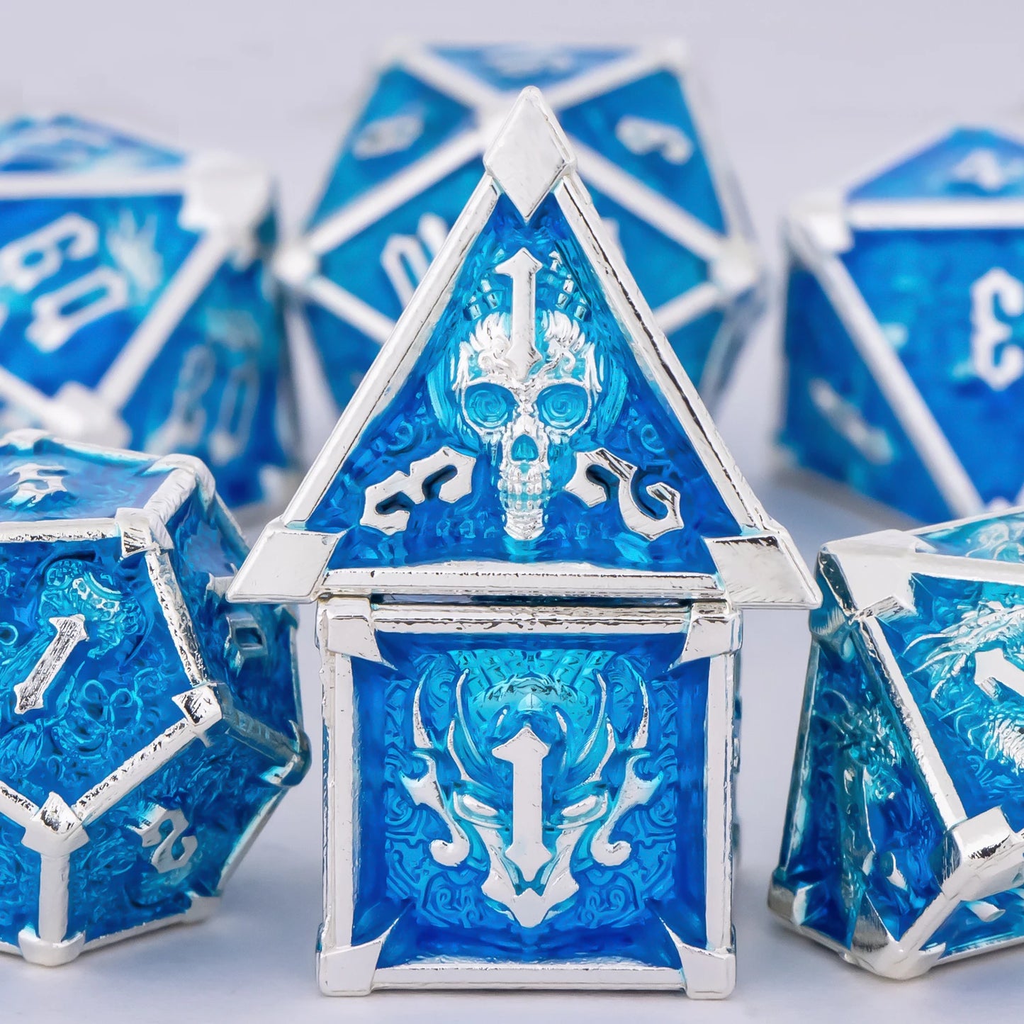 Blue and silver polyhedral dice set on a light gray background