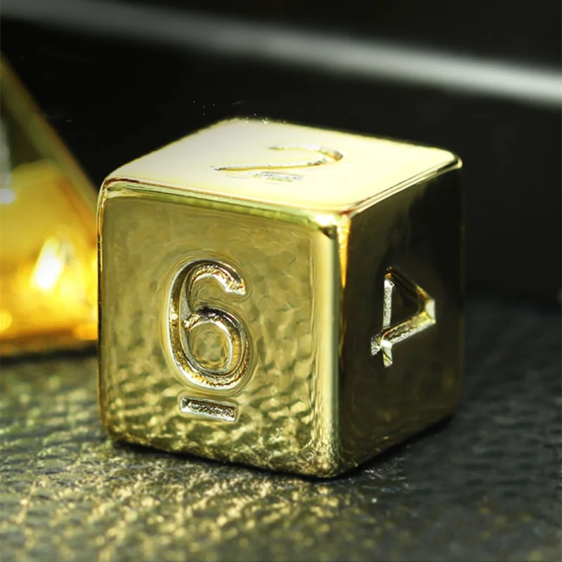 Gold die with numbers on a dark background