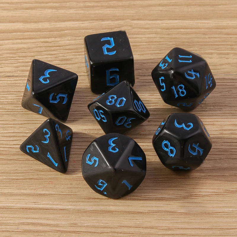Black dice with blue numbers on a wooden surface