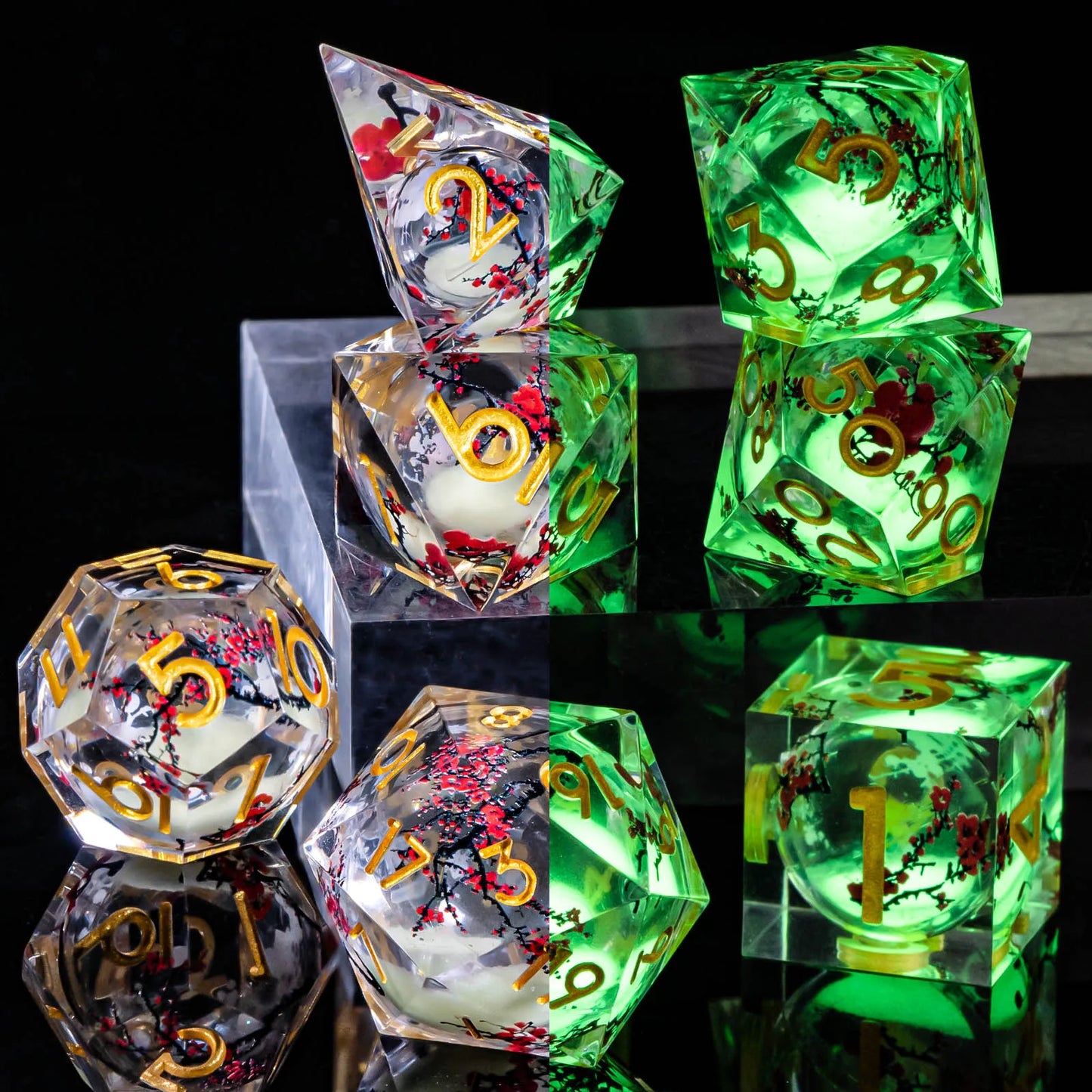 A set of transparent acryilic dice with a silver glitter and cherry blossom liquid core, and gold numbering. The image is split down the middle, the left showing the die in normal light, while on the right, the glitter is glowing bright green showing that it glows in the dark.