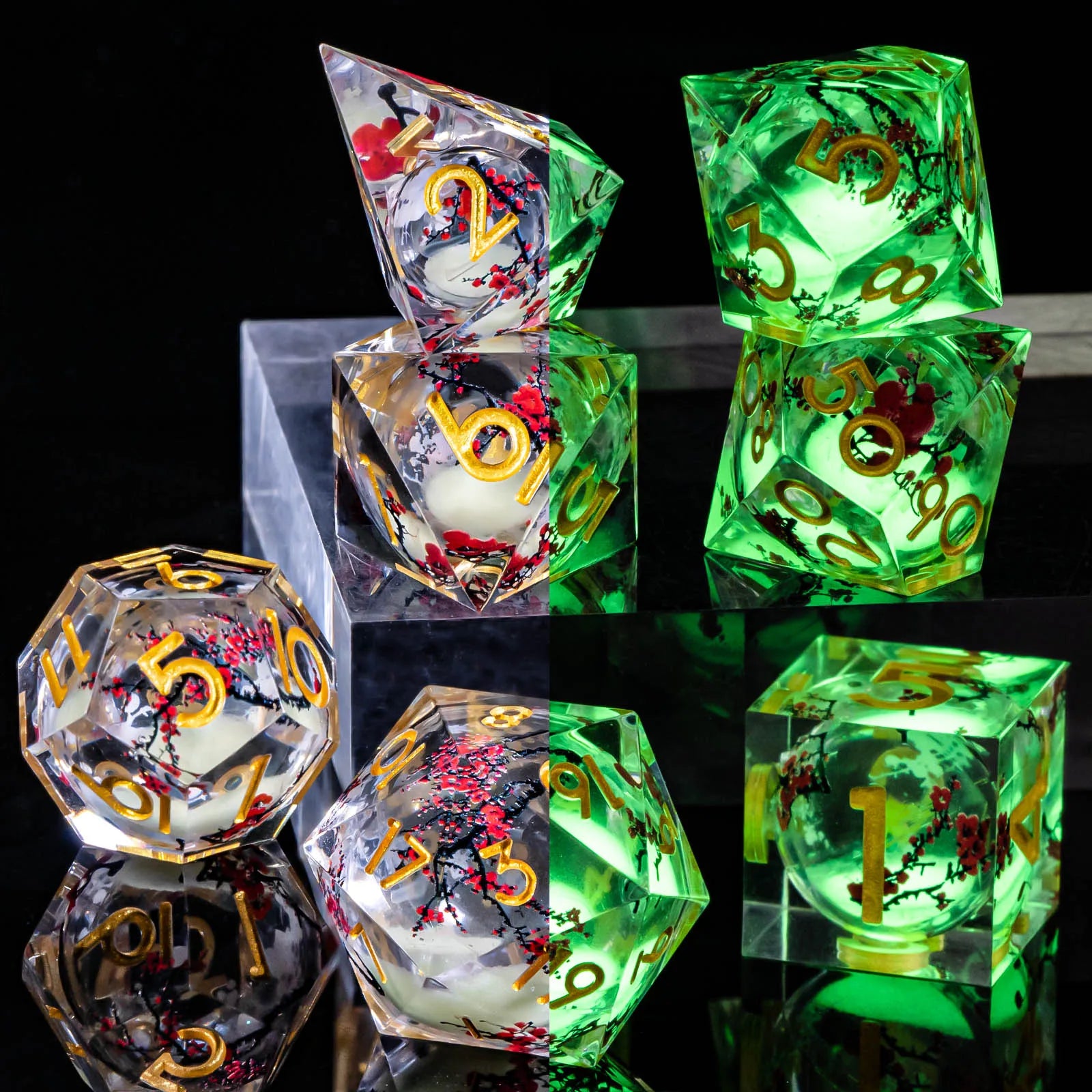 A set of transparent acryilic dice with a silver glitter and cherry blossom liquid core, and gold numbering. The image is split down the middle, the left showing the die in normal light, while on the right, the glitter is glowing bright green showing that it glows in the dark.