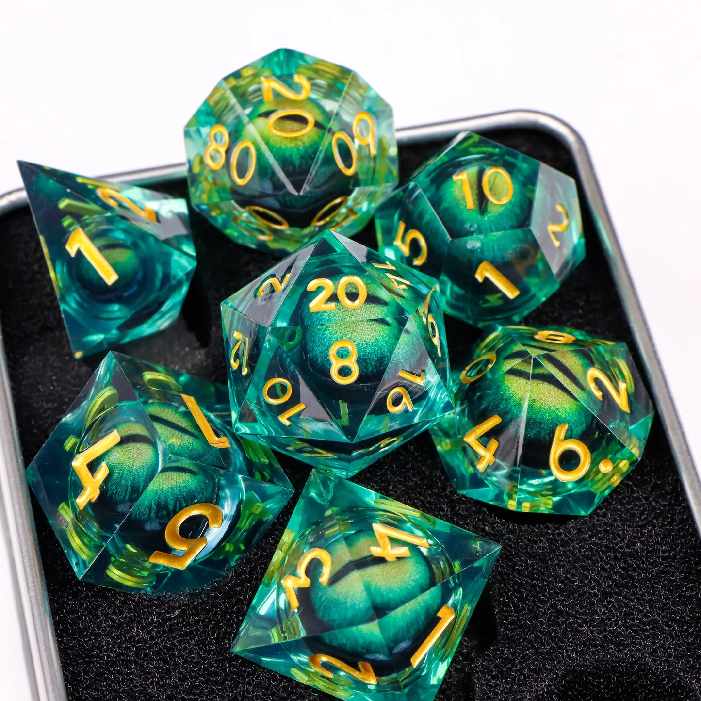 A set of green translucent ttrpg dice with gold numbering. Inside each die there is a liquid core, containing a fantasy eye staring upwards.