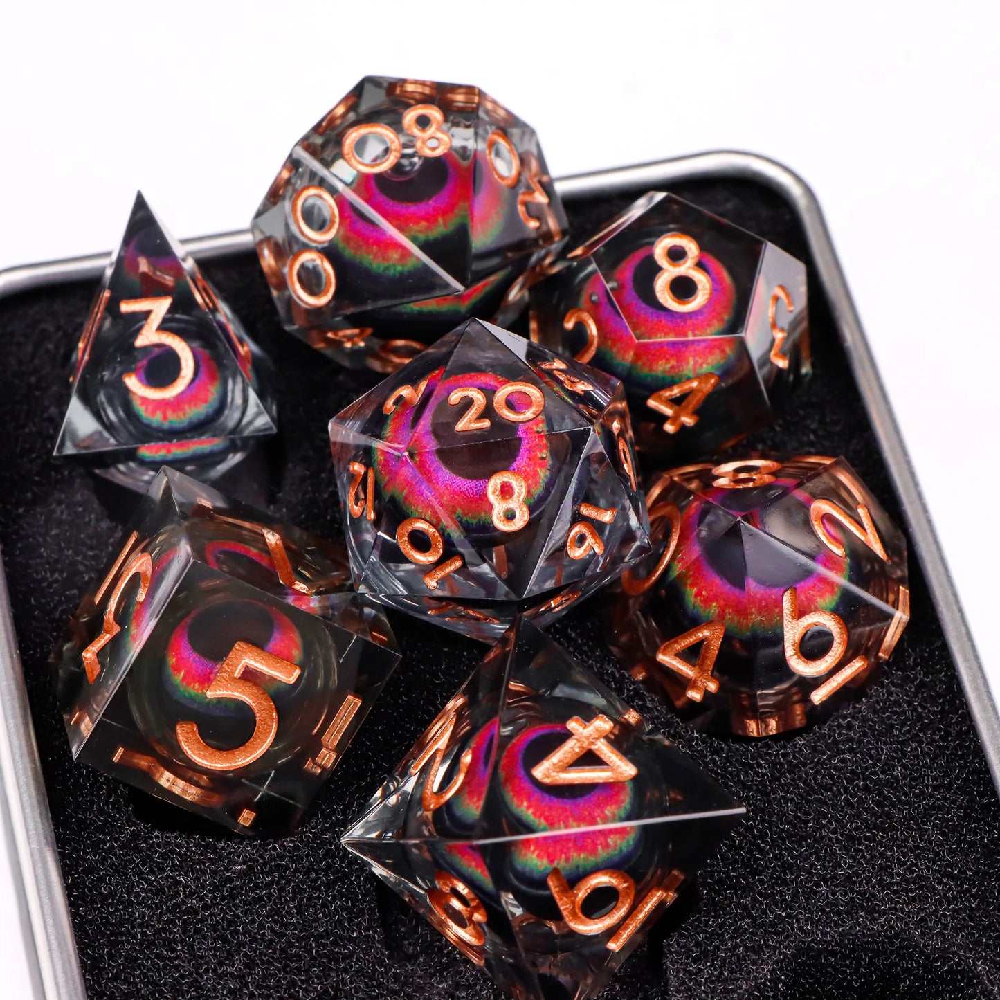 A set of translucent ttrpg dice with copper numbering. Inside each die there is a liquid core, containing a fantasy eye staring upwards.