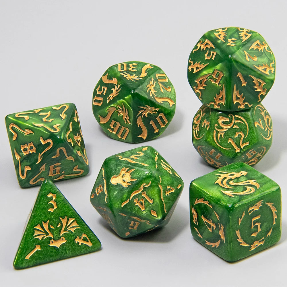 A set of green polyhedral tabletop gaming dice with gold engraved symbols, arranged on a light gray background.
