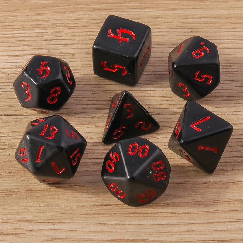 Black dice with red numbers on a wooden surface
